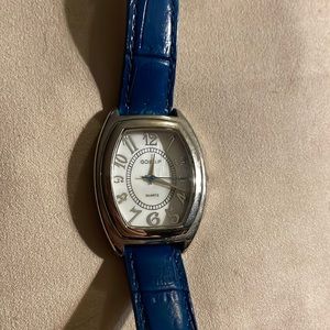Beautiful blue leather watch. It in new, never worn. It is Quartz.